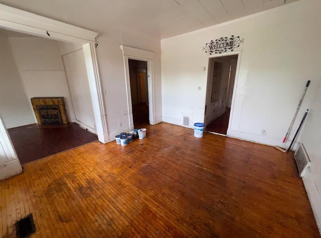 unfurnished living room with hardwood / wood-style flooring and a fireplace