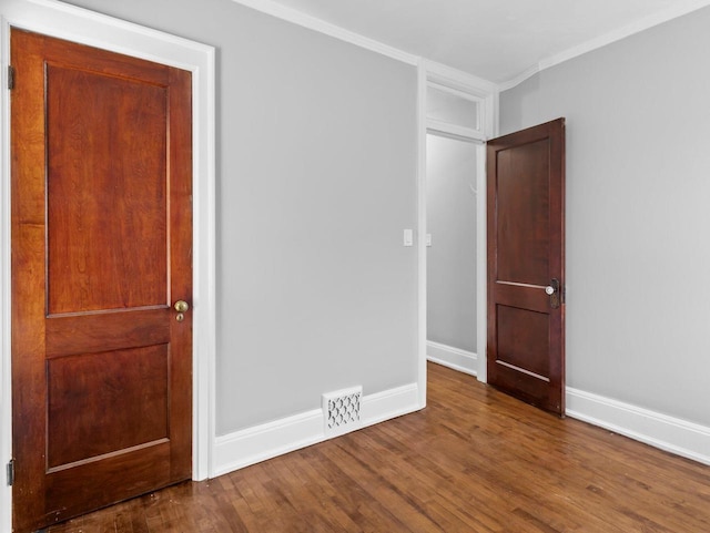 unfurnished bedroom featuring ornamental molding and hardwood / wood-style floors