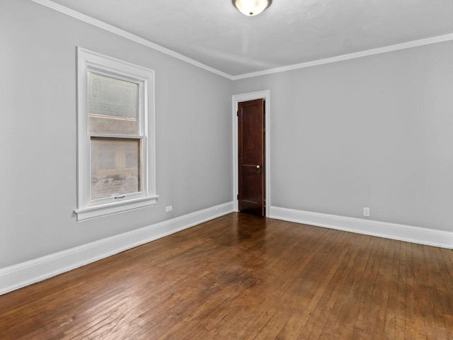 spare room with ornamental molding and dark wood-type flooring