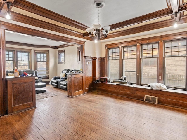 office with hardwood / wood-style floors, ornamental molding, and a chandelier