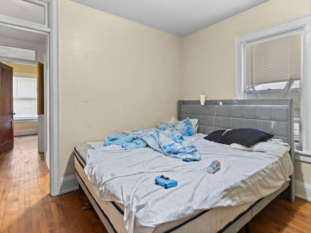 bedroom with dark wood-type flooring