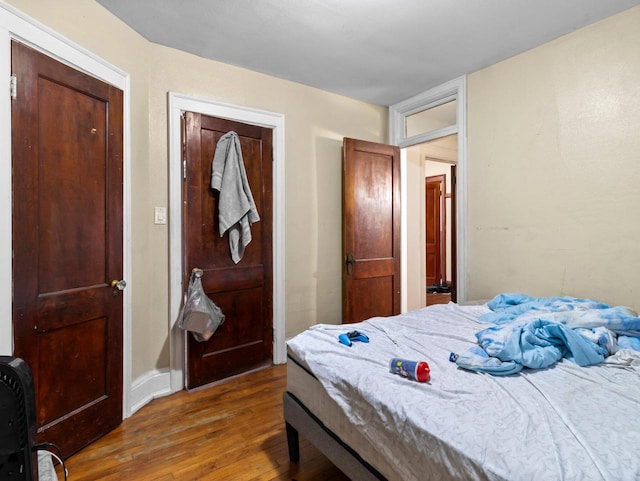 bedroom with dark hardwood / wood-style floors