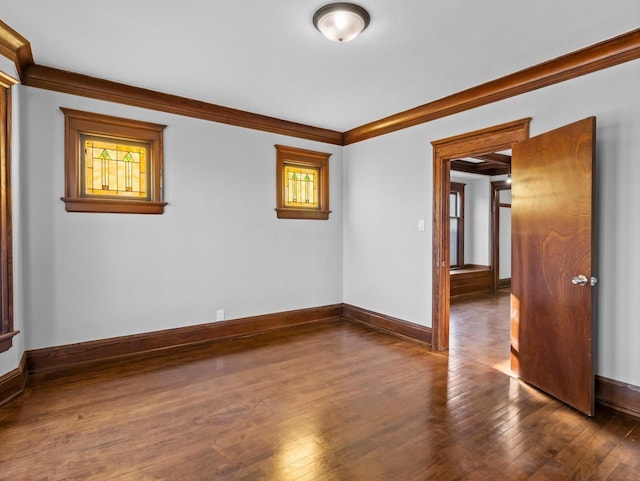 unfurnished room with crown molding and dark wood-type flooring