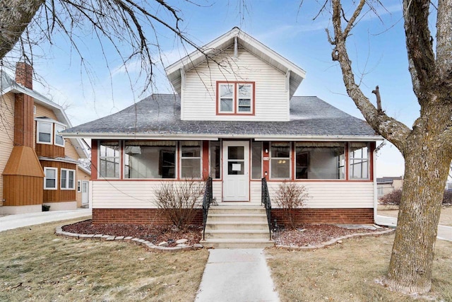 view of front of house with a front lawn and a porch