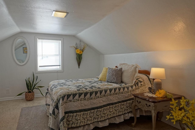 bedroom featuring carpet floors, vaulted ceiling, and a textured ceiling