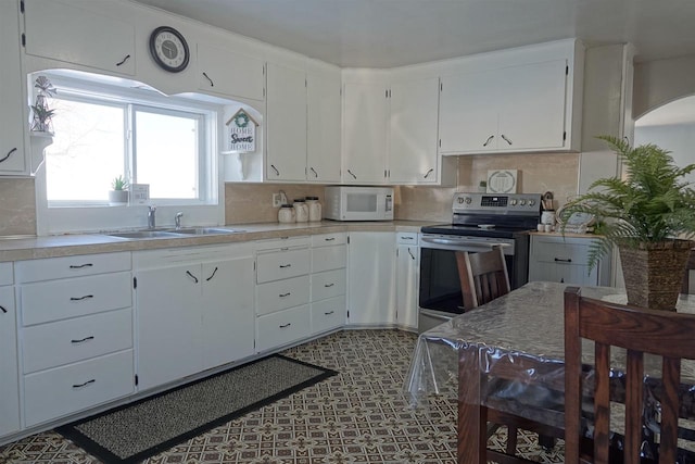 kitchen featuring white cabinetry, stainless steel electric stove, sink, and decorative backsplash