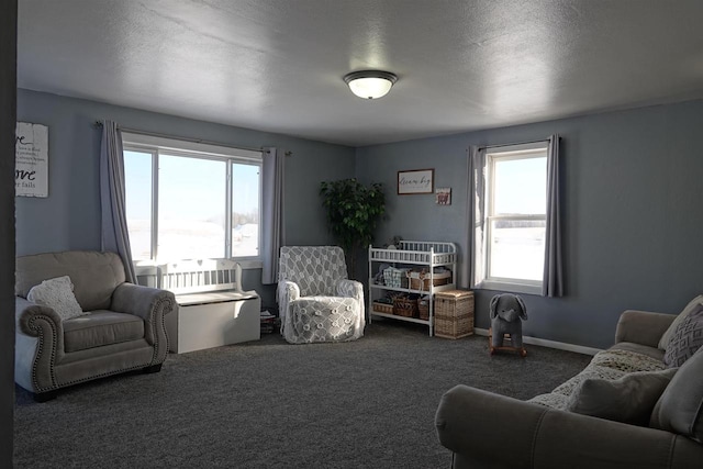 living room with a textured ceiling and dark colored carpet