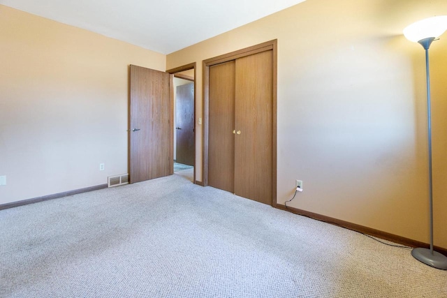 unfurnished bedroom with carpet floors and a closet