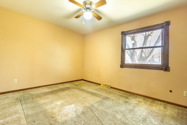 carpeted spare room with ceiling fan