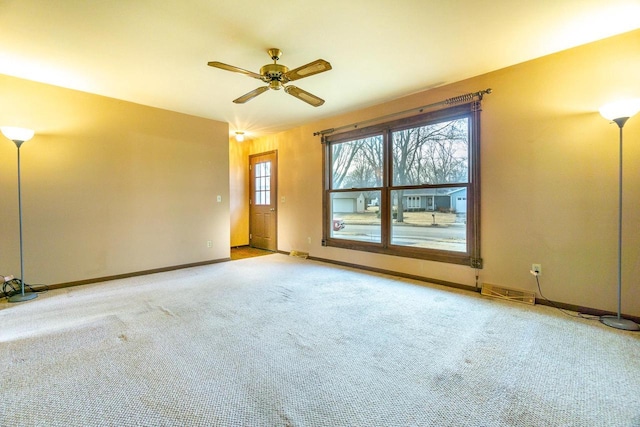 unfurnished room with ceiling fan and light carpet