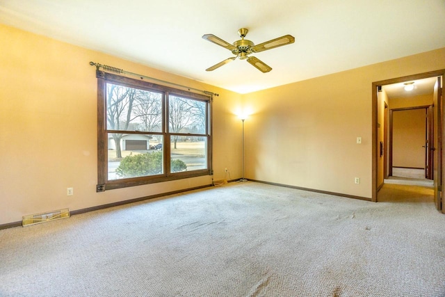 spare room with light carpet and ceiling fan