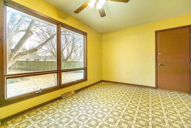 unfurnished sunroom with ceiling fan