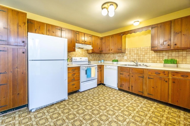 kitchen with tasteful backsplash, sink, and white appliances