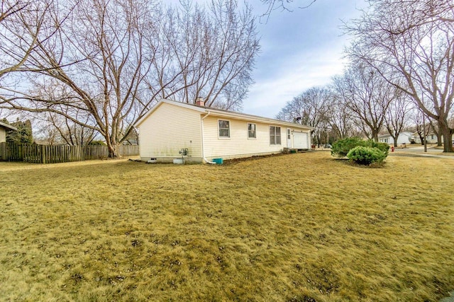 view of side of property with a yard