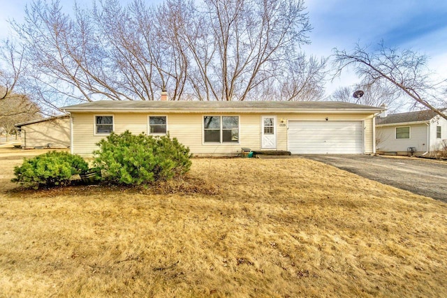 single story home with a garage and a front yard