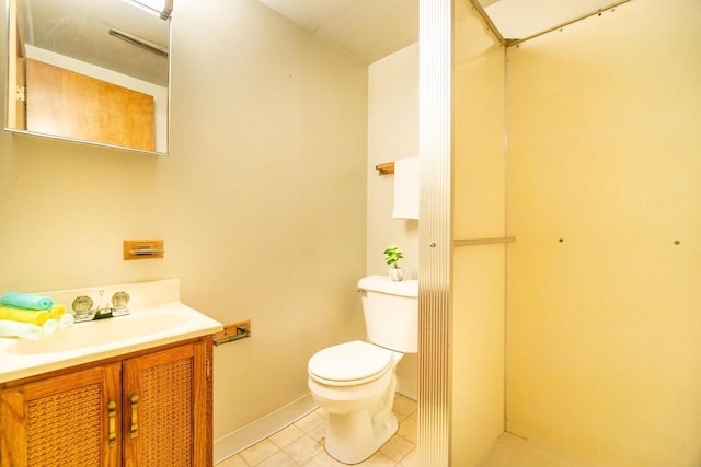 bathroom featuring tile patterned flooring, vanity, and toilet