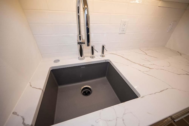 interior details featuring sink and light stone counters