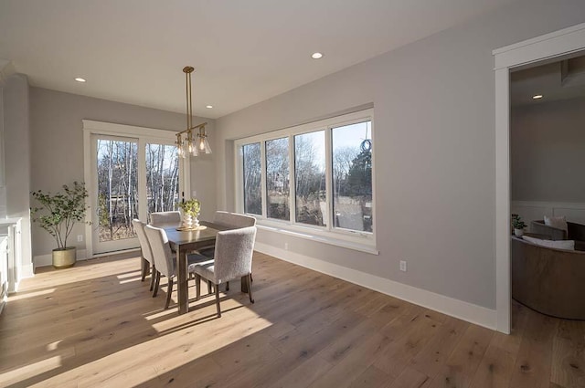 dining room with a notable chandelier and light wood-type flooring