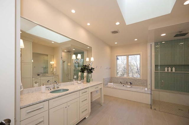 bathroom with tile patterned flooring, plus walk in shower, and vanity