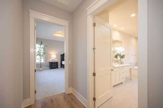 hallway featuring light carpet