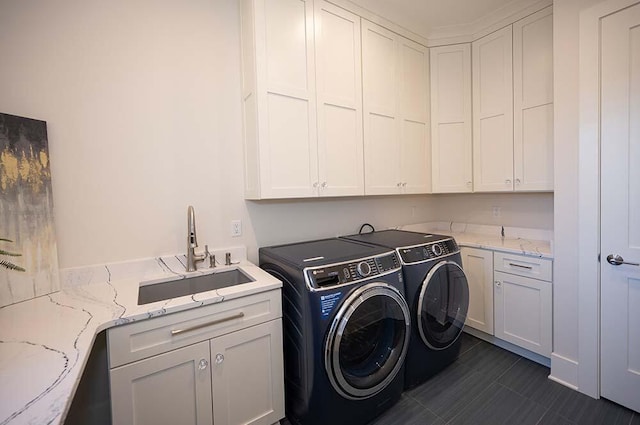 washroom with sink, cabinets, and independent washer and dryer