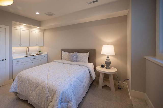 carpeted bedroom featuring sink