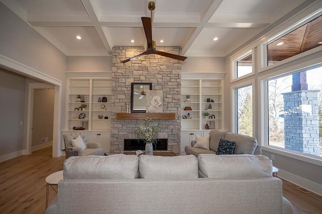 living room with hardwood / wood-style floors, built in features, a fireplace, coffered ceiling, and beam ceiling