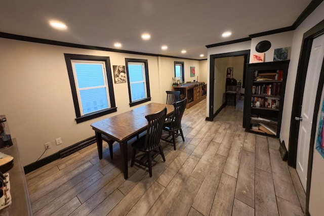 dining area with crown molding and light wood-type flooring