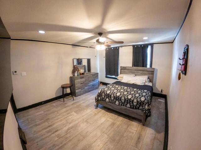 bedroom with ceiling fan and light hardwood / wood-style floors