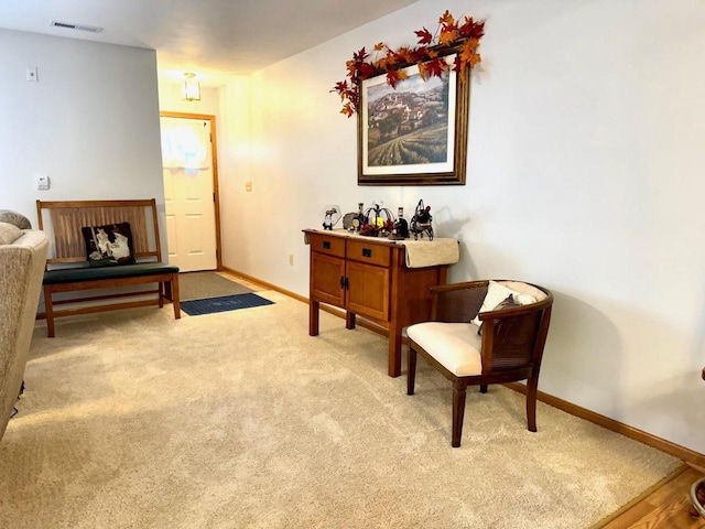 living area with light carpet