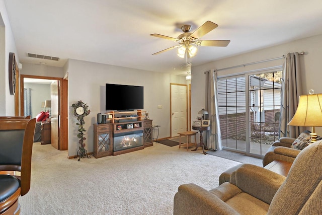 carpeted living room featuring ceiling fan