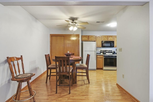 dining area featuring ceiling fan and light hardwood / wood-style flooring