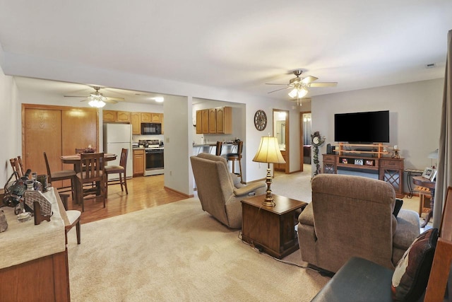 living room with light colored carpet and ceiling fan