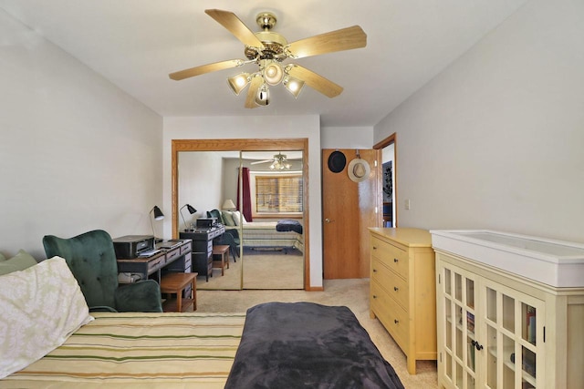 carpeted bedroom with a closet and ceiling fan