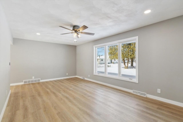 unfurnished room with ceiling fan and light wood-type flooring