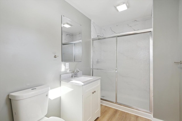 bathroom featuring vanity, toilet, an enclosed shower, and wood-type flooring