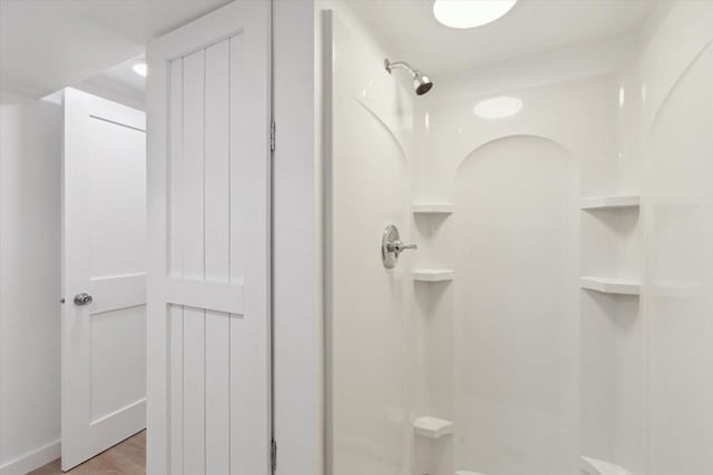 bathroom with walk in shower and hardwood / wood-style flooring