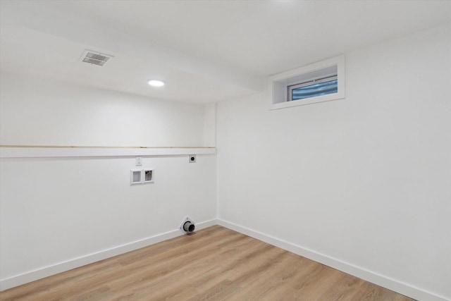 washroom featuring hookup for a washing machine, hookup for an electric dryer, and light hardwood / wood-style flooring