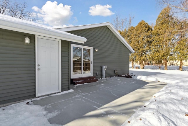 view of snow covered property entrance