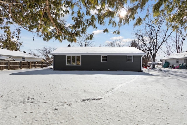 view of snow covered rear of property