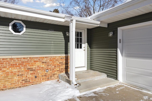 view of exterior entry with a garage