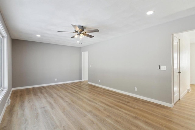 spare room featuring ceiling fan and light hardwood / wood-style floors