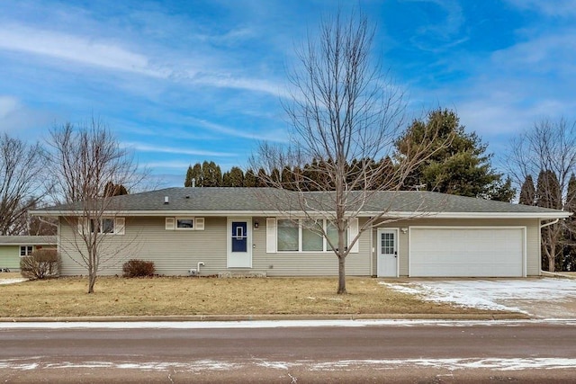 ranch-style home with a garage and a front yard