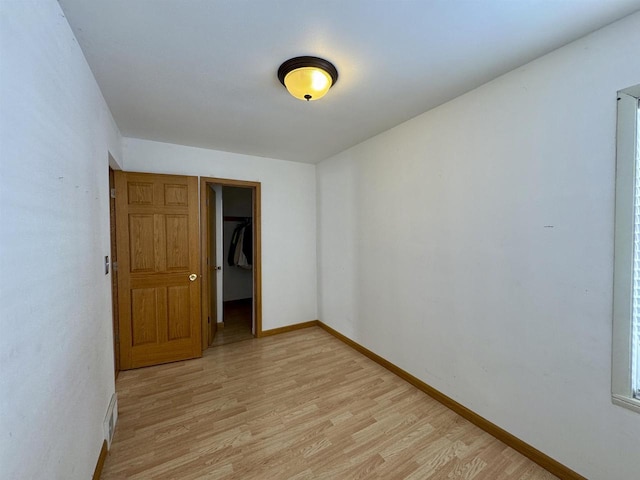 spare room featuring light hardwood / wood-style floors