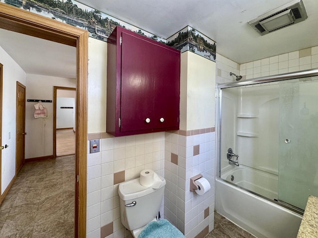 bathroom featuring enclosed tub / shower combo, toilet, and tile walls