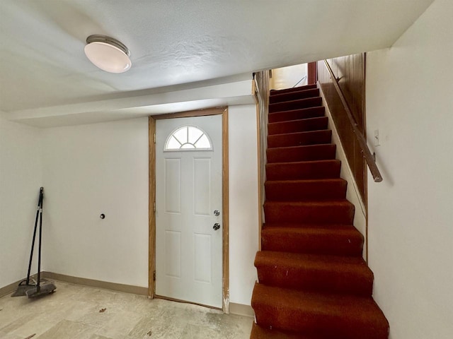 foyer entrance featuring a textured ceiling