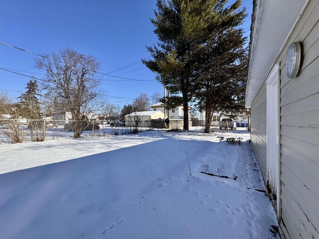 view of yard layered in snow