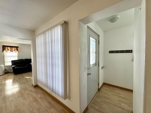 corridor with light hardwood / wood-style flooring