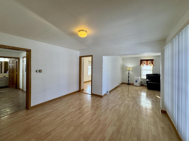 unfurnished room featuring sink and light hardwood / wood-style flooring