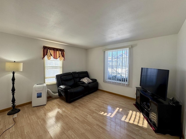 living room featuring a textured ceiling and light wood-type flooring